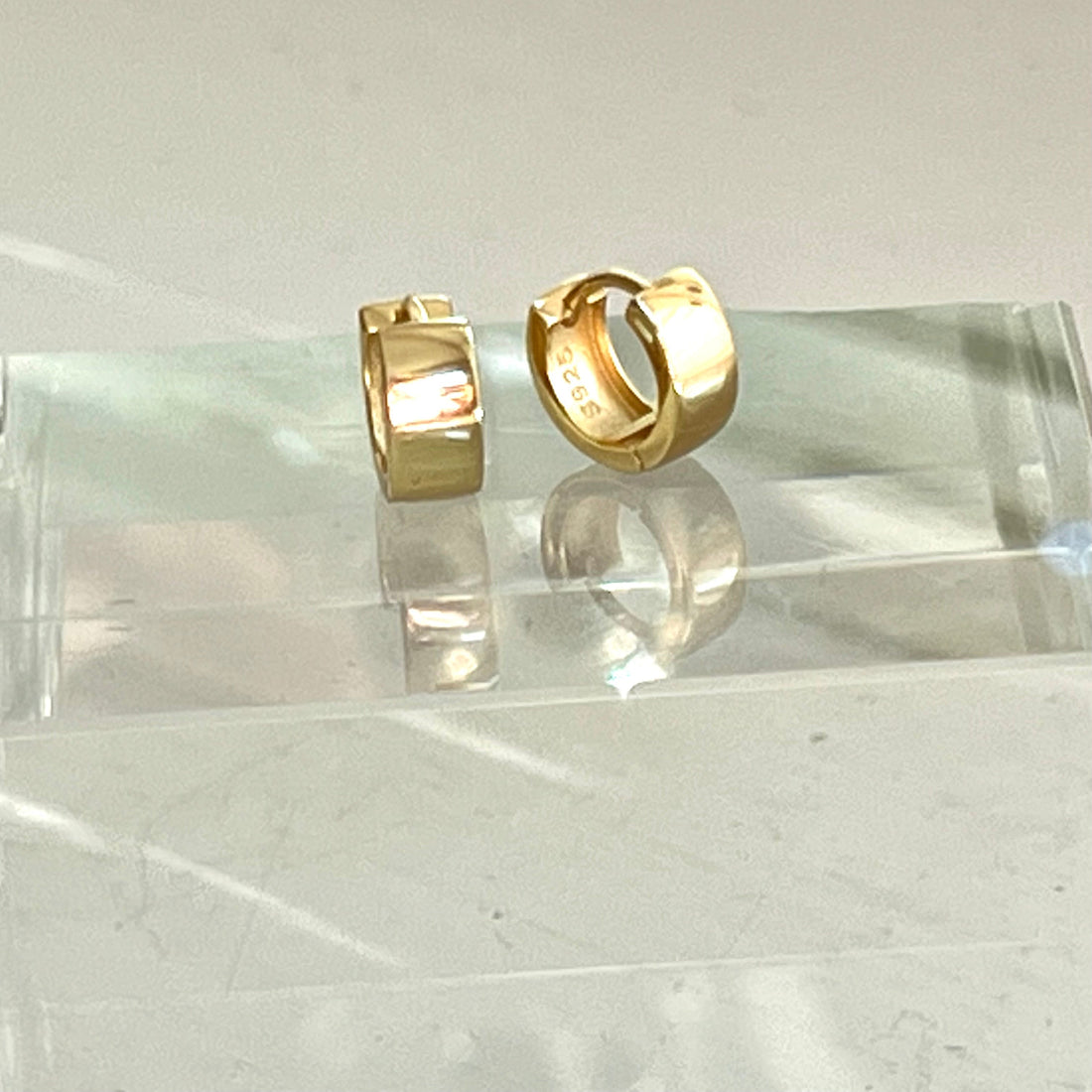 Silver earrings before and after tarnish cleaning with baking soda