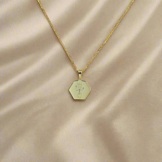 Meli honeycomb shape gold plated pendant with actual drawing engraved on it. Made by Chapters of Joy