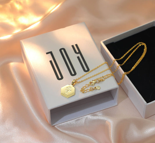 MELI honeycomb shape gold plated pendant with actual drawing engraved on it. Chapters of JOY.
