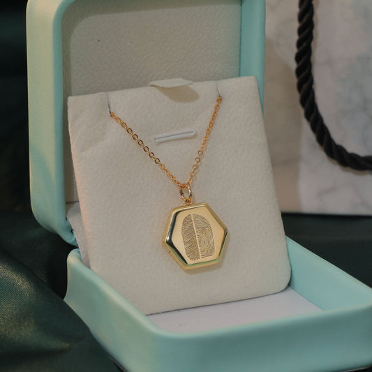 Gold fingerprint locket with two joined prints and photo inside — handcrafted by Chapters of Joy.