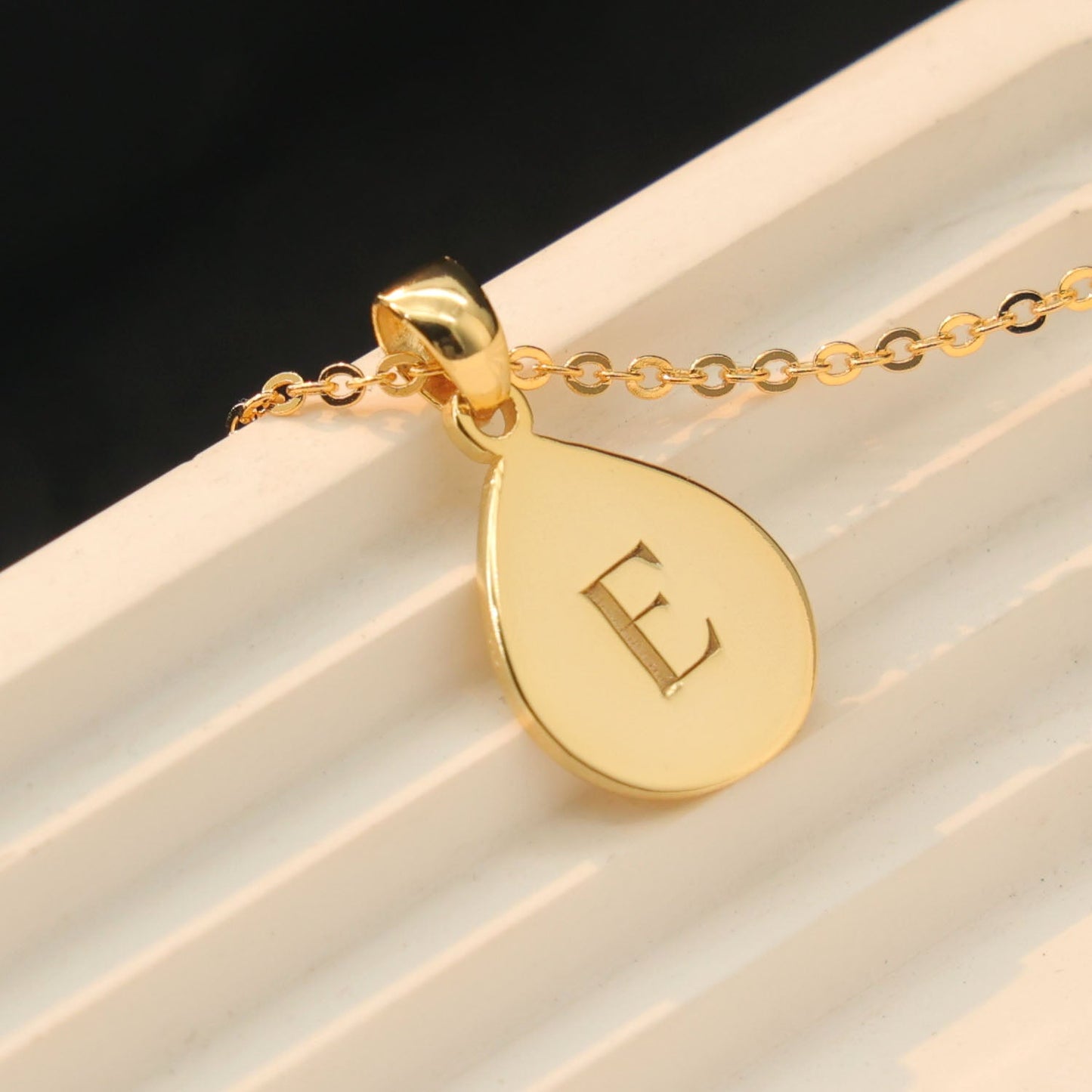Custom drop shape pendant engraved with a loved one’s  initials