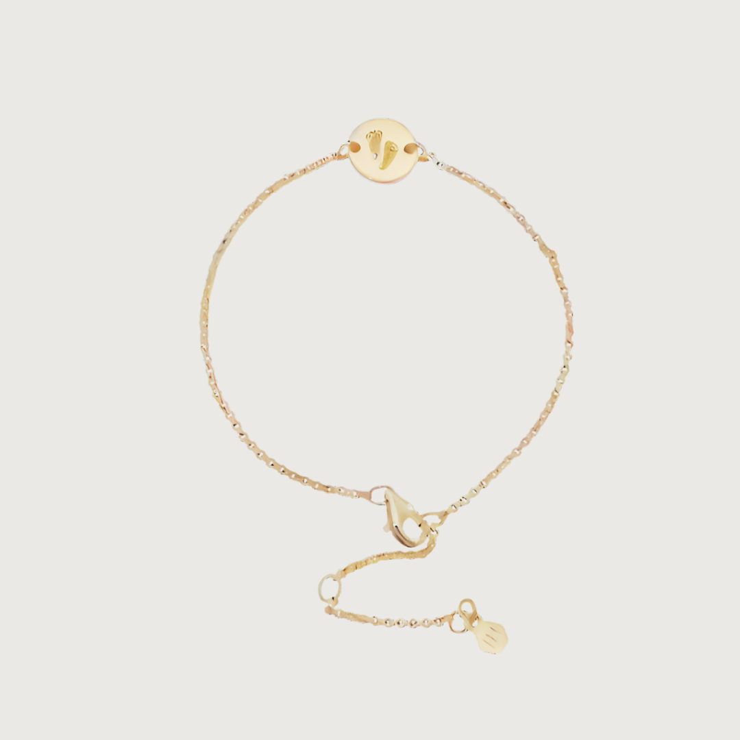 Custom bracelet engraved with footprints — sentimental gold keepsake.
