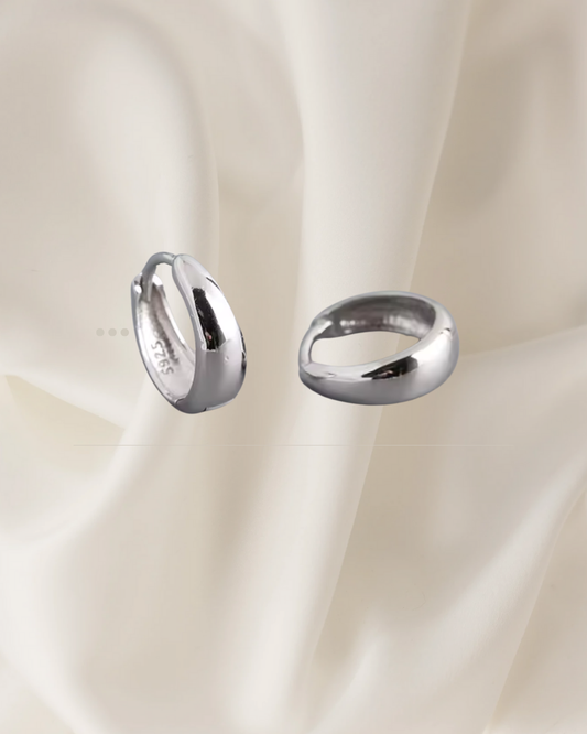 Domed silver hoop earrings with a smooth, radiant finish — Sola Hoops by Chapters of Joy.