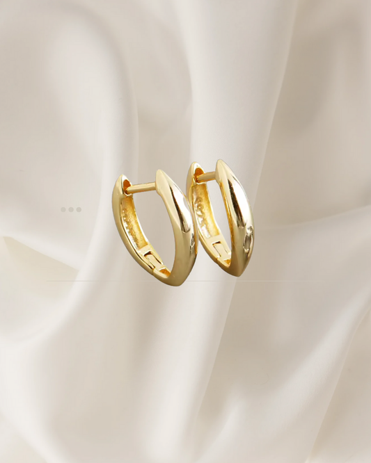 Elongated sculptural gold hoop earrings with soft curves — Auri Hoops by Chapters of Joy.