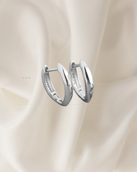 Elongated sculptural silver hoop earrings with soft curves — Auri Hoops by Chapters of Joy.