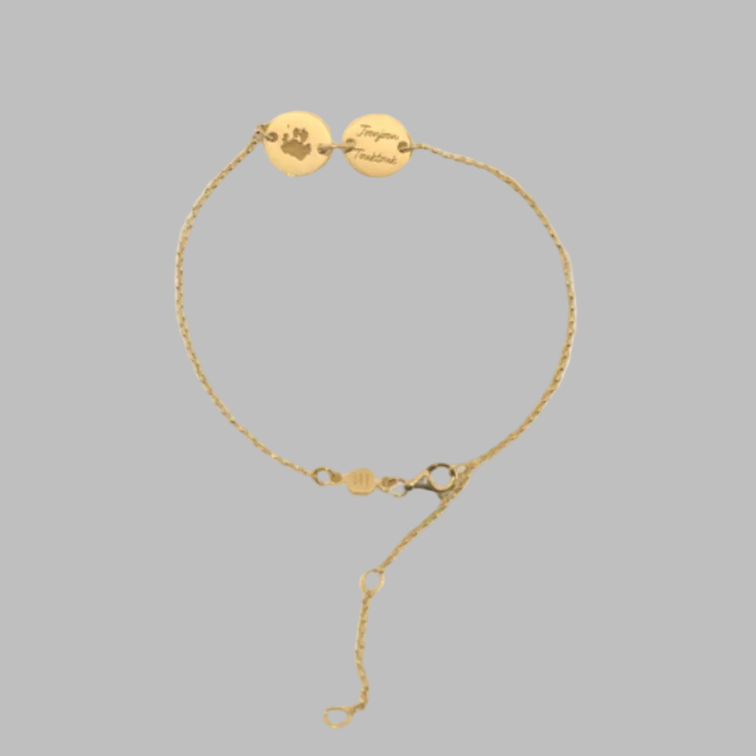 Gold bracelet engraved with pet paw print and name. great custom keepsake jewelry from Chapters of Joy.