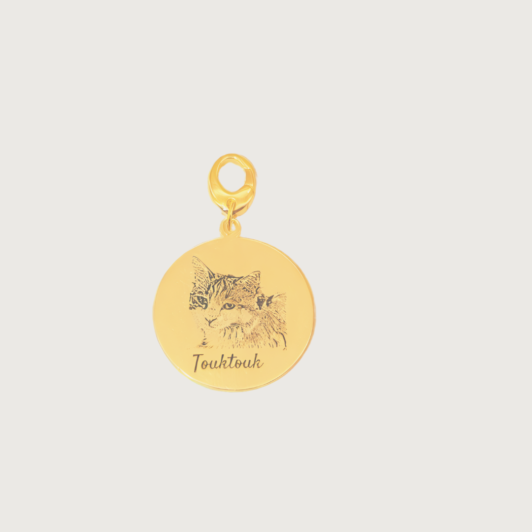 Gold plated Duo Tag engraved with two cat faces, symbolizing the bond between beloved companions.