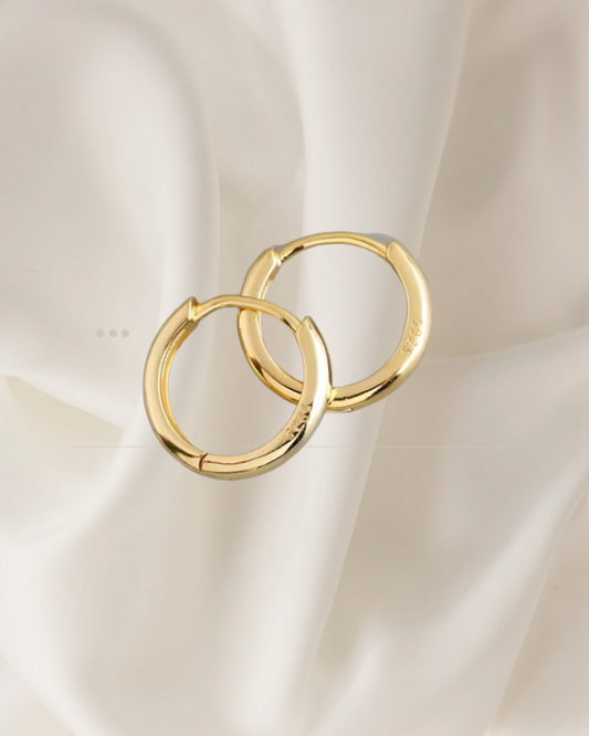 Minimalist gold, medium size hoop earrings in two sizes, designed for everyday elegance — Ena Hoops by Chapters of Joy.