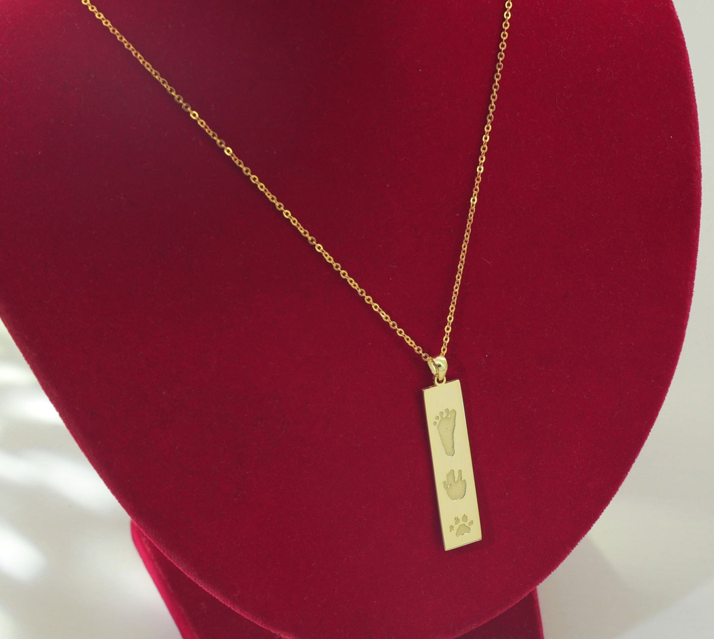 Flat lay of The Dila Pendant showcasing double-sided engraving options