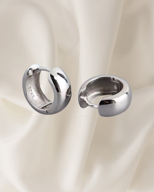 Polished silver hoop earrings with rounded shape and timeless shine — Nora Hoops by Chapters of Joy.