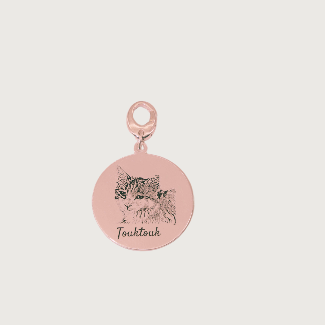 Rose Gold plated Duo Tag engraved with two cat faces, symbolizing the bond between beloved companions.