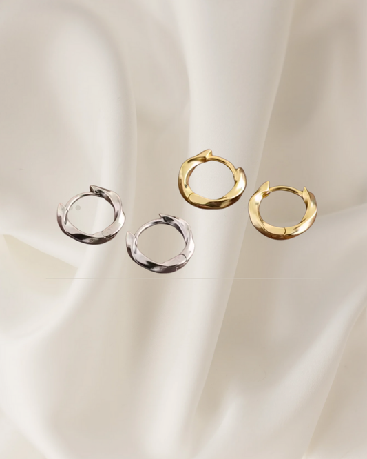 Sculpted gold and silver hoop earrings with gentle flowing curves — Wavelet Hoops by Chapters of Joy.