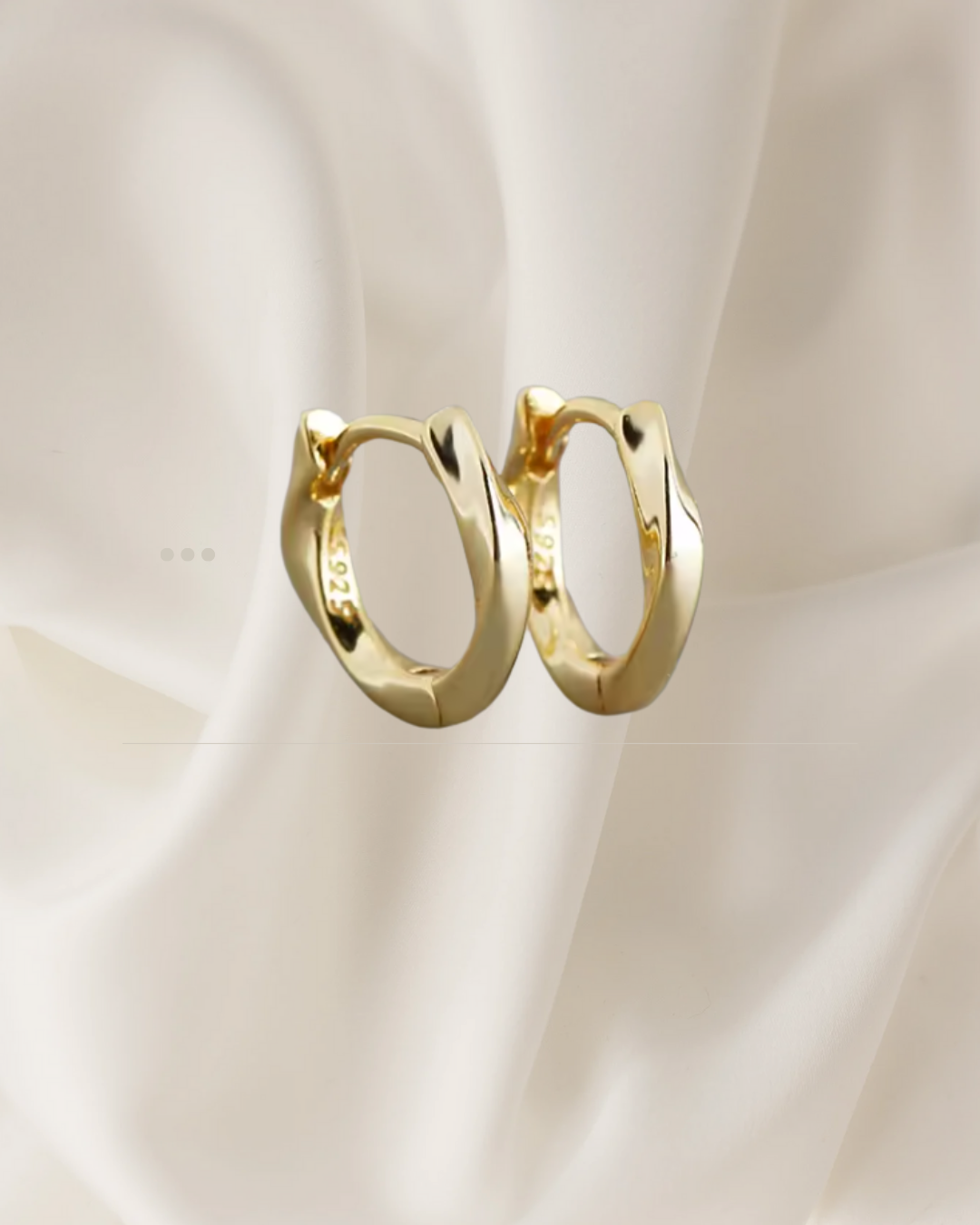 Sculpted gold hoop earrings with gentle flowing curves — Wavelet Hoops by Chapters of Joy.