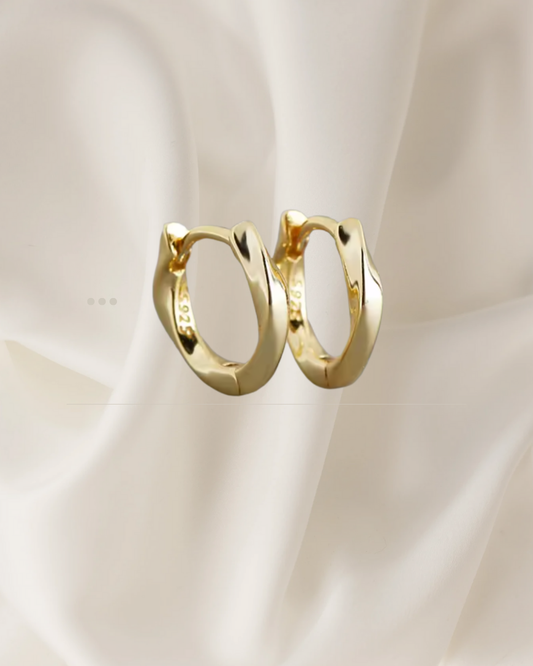 Sculpted gold hoop earrings with gentle flowing curves — Wavelet Hoops by Chapters of Joy.