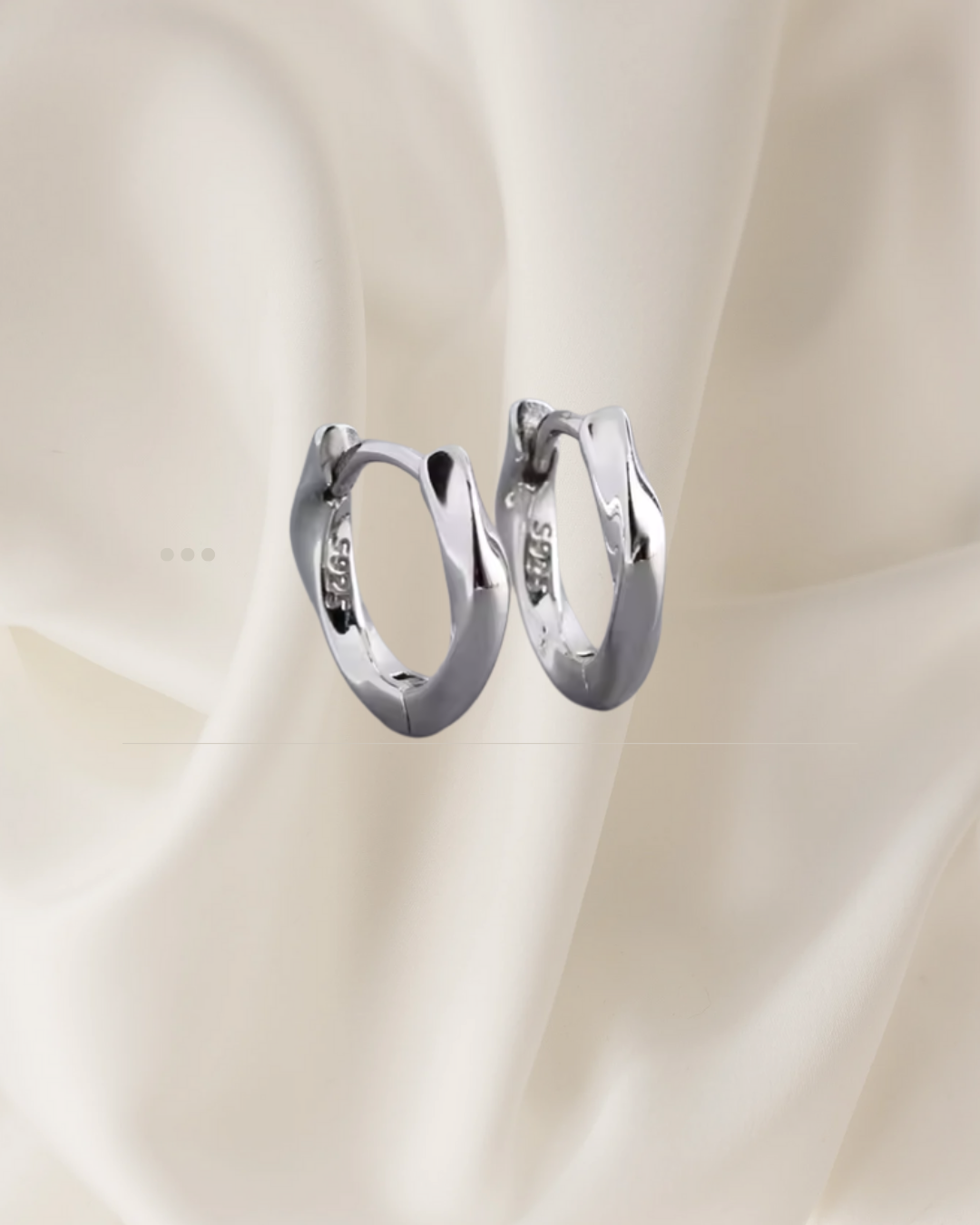 Sculpted silver hoop earrings with gentle flowing curves — Wavelet Hoops by Chapters of Joy.
