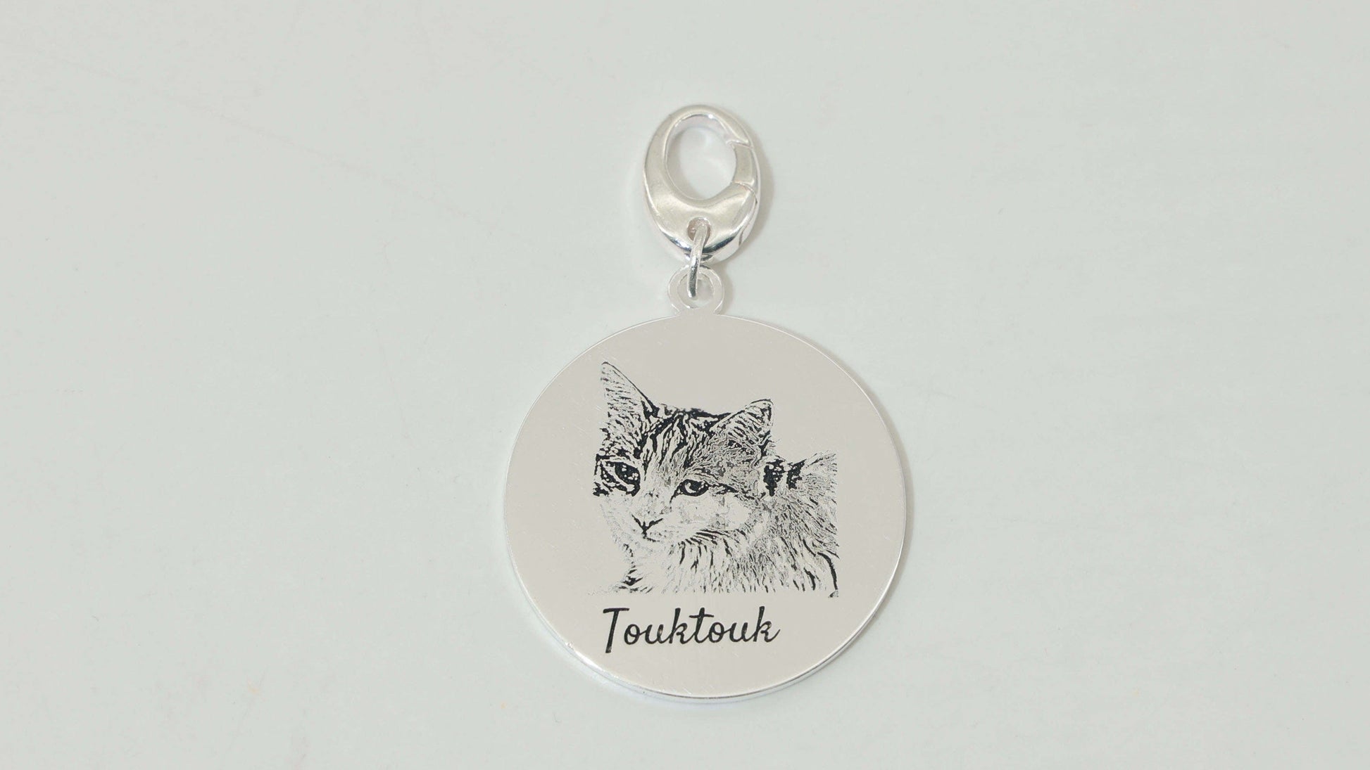 Sterling silver Duo Tag engraved with a different cat face on each side