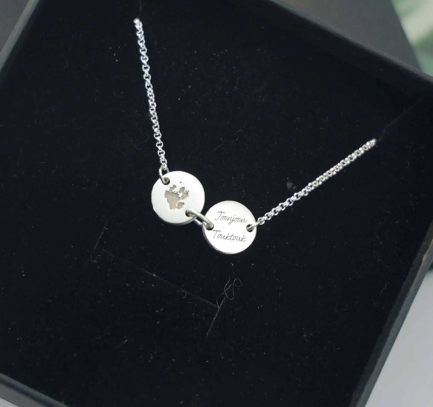 Sterling silver bracelet engraved with pet paw print and name — custom keepsake jewelry from Chapters of Joy.