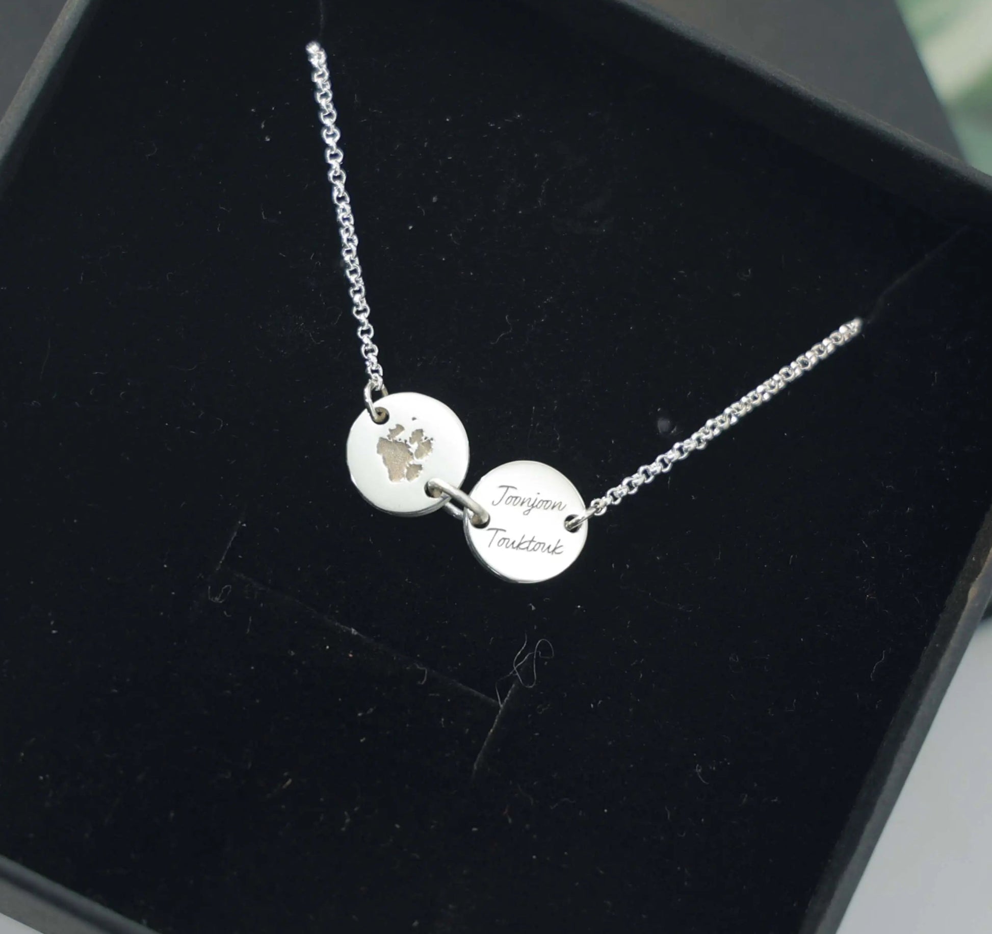 Sterling silver bracelet engraved with pet paw print and name — custom keepsake jewelry from Chapters of Joy.