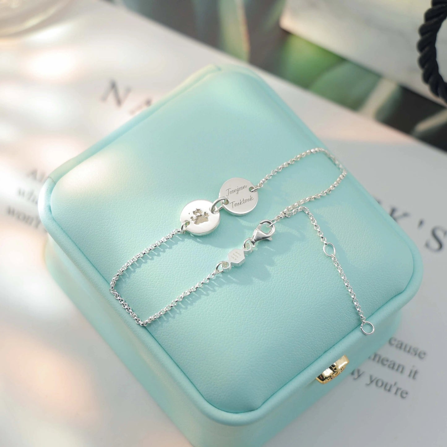 Sterling silver bracelet engraved with pet paw print and name — custom keepsake jewelry from Chapters of Joy.