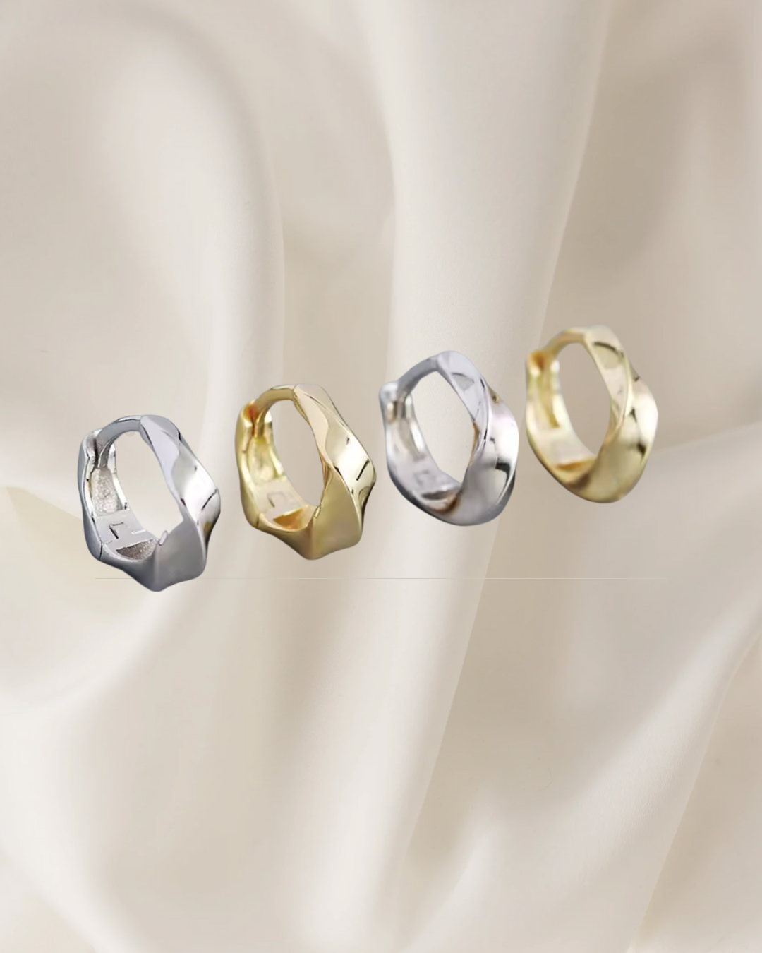 Twisted sterling silver and gold hoop earrings reflecting light and movement — Lira Hoops by Chapters of Joy
