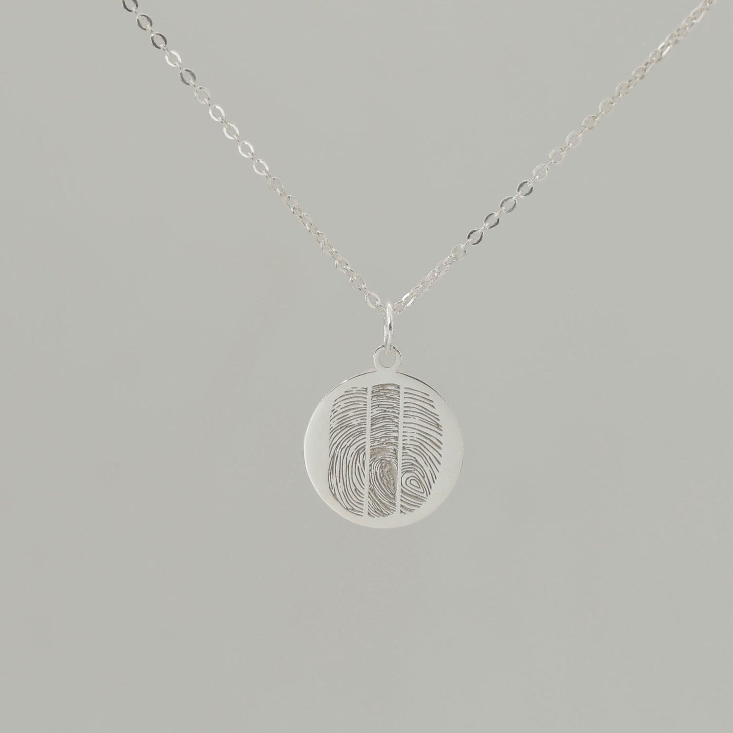 Custom engraved pendant with fingerprints and ‘Together as one’ inscription