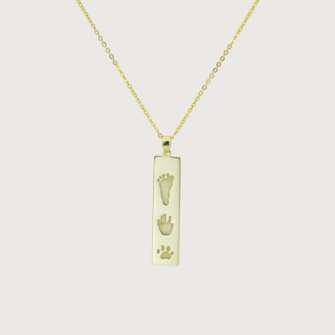Flat lay of The Dila Pendant showcasing double-sided engraving options