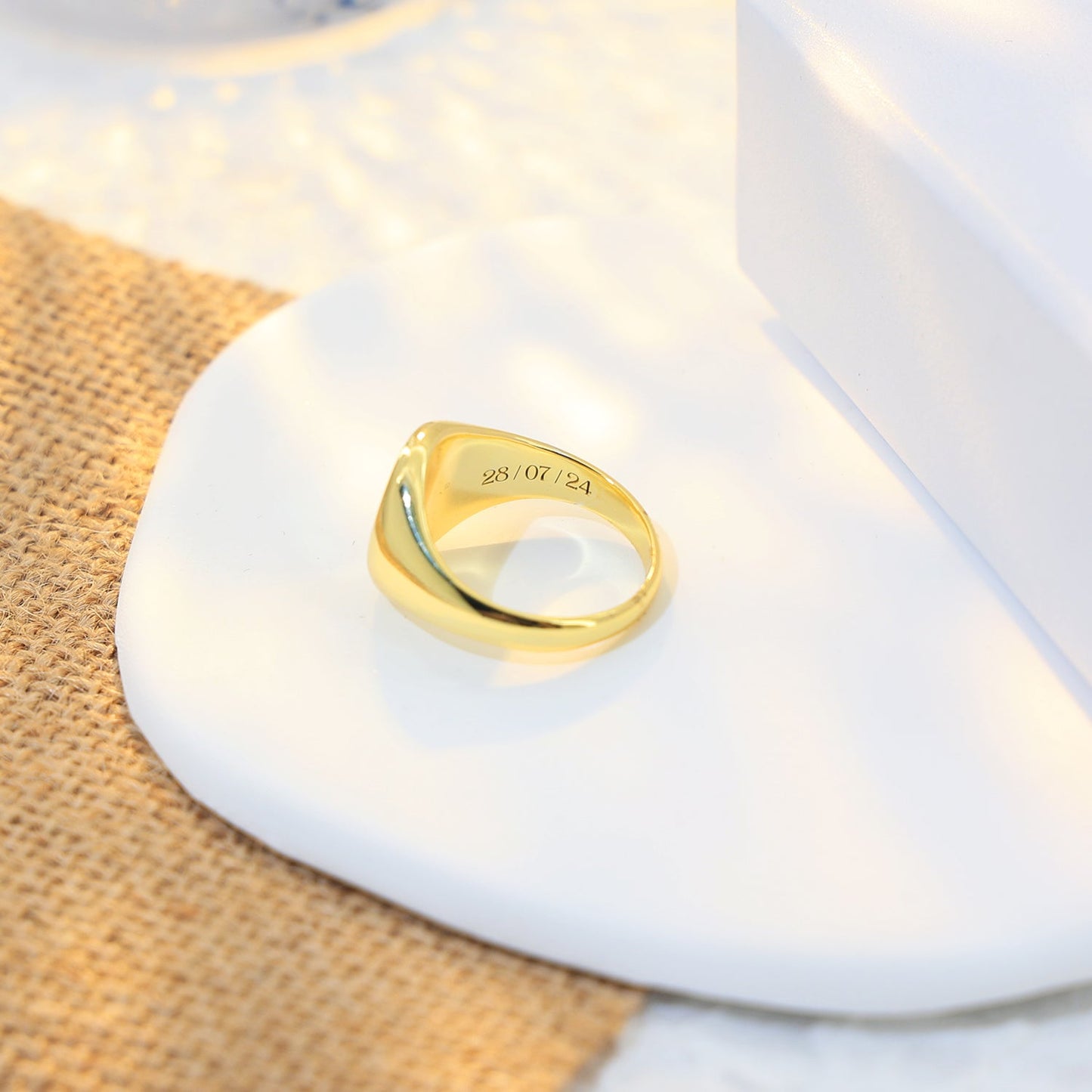 Gold plated signet ring engraved with a loved one’s handprint.
Inside is the birth date engraved