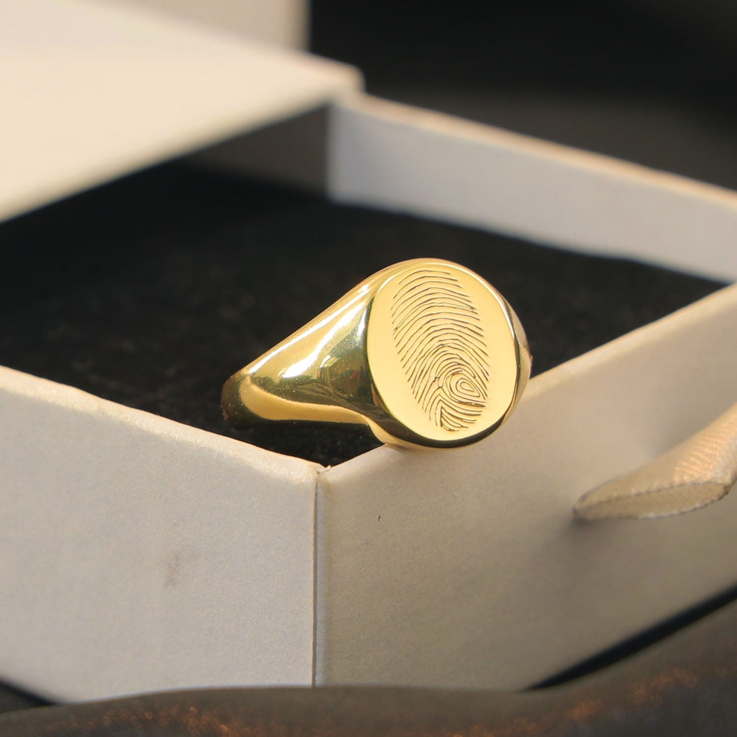 Layla Signet Ring in gold with fingerprint engraving on band.