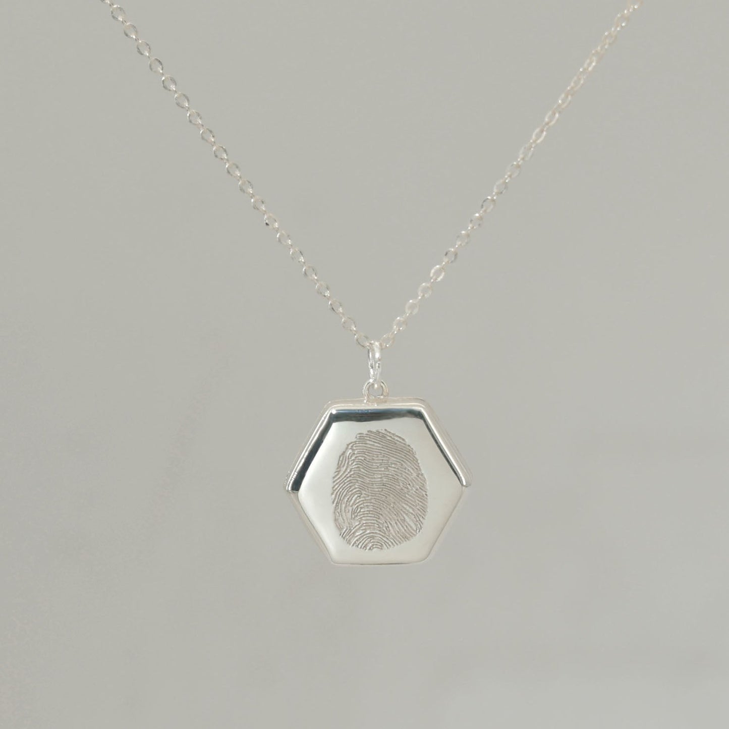Sterling silver Lina Locket with fingerprint engraving, handwritten message, and UV-lasered photograph inside.
