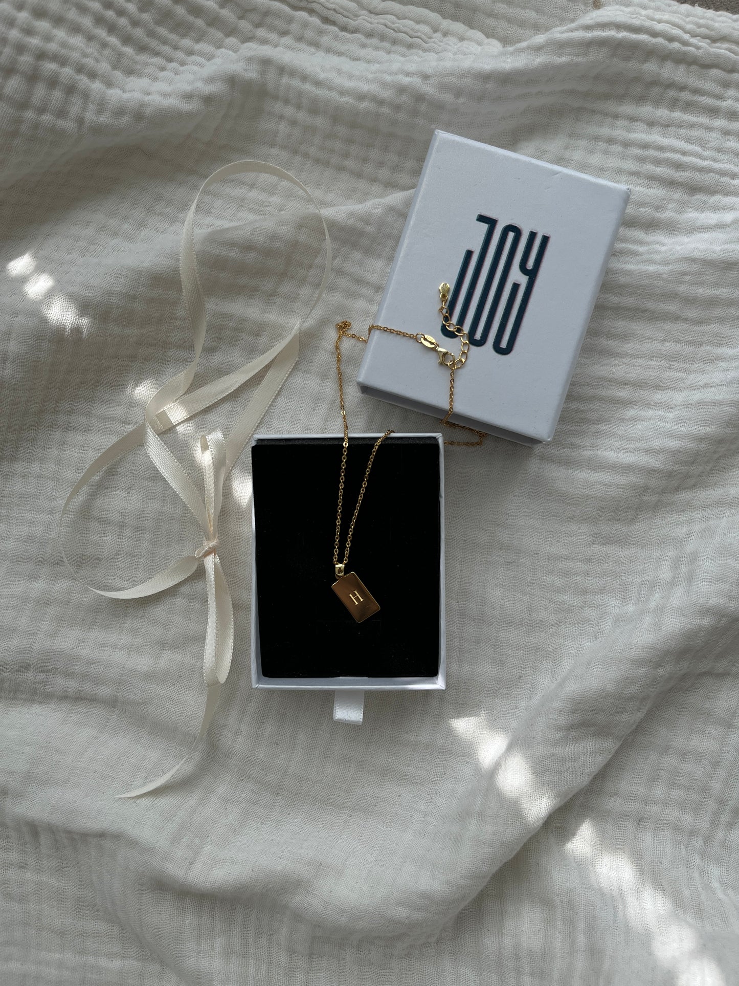 Personalized rectangular pendant engraved with initial