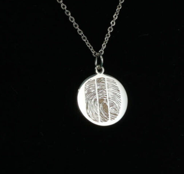 Personalized fingerprint necklace in sterling silver on black background