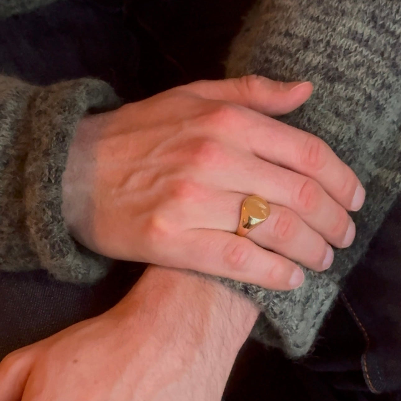 Close-up of a hand wearing Layla signet ring 14k gold plated with fingerprint engraving on it.personal keepsake