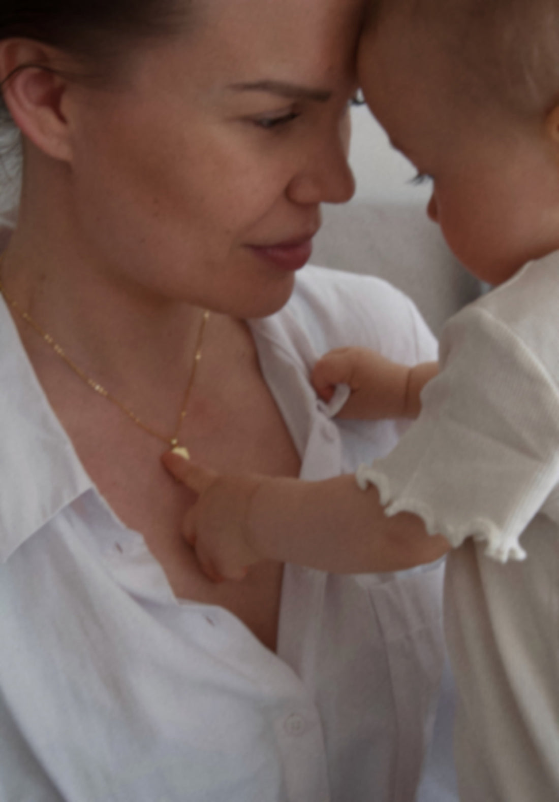 Woman wearing custom fingerprint pendant, emotional keepsake jewelry