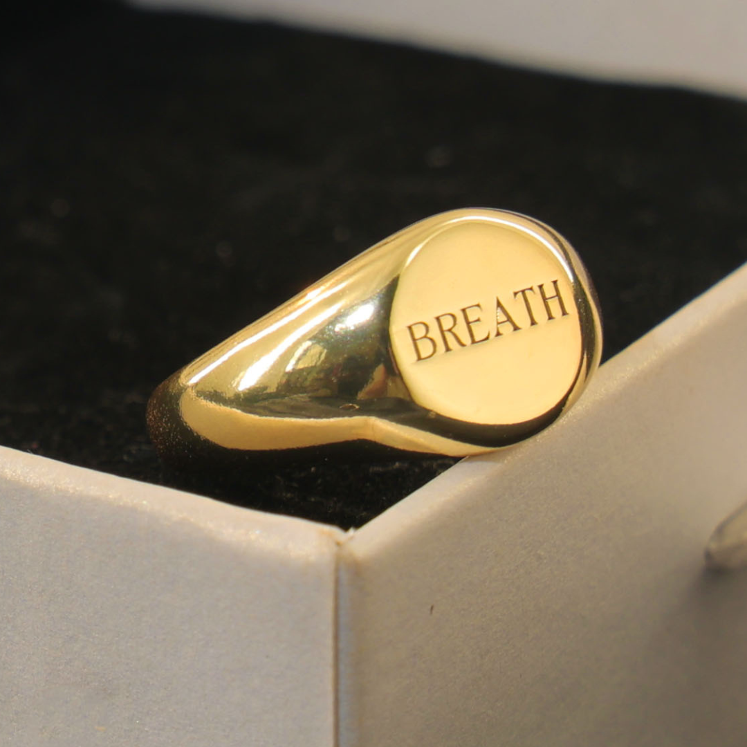 Gold signet ring engraved with a word to remember — custom engraved signet ring by Chapters of Joy.