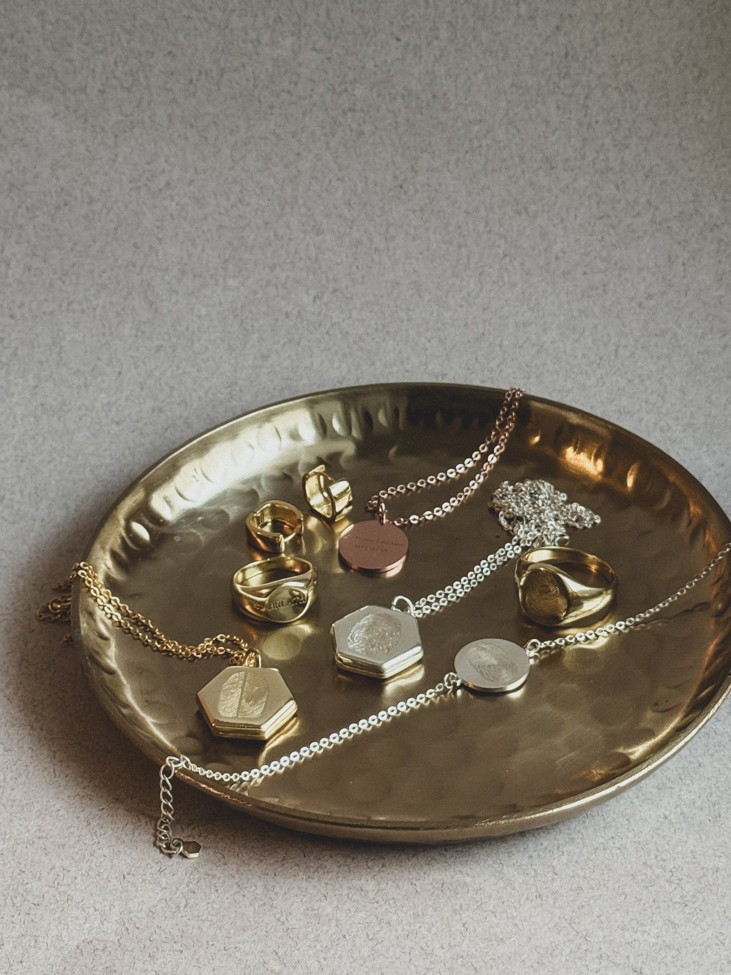 Gold and silver personalized keepsake jewelry — fingerprint lockets, engraved rings, and necklaces handcrafted by Chapters of Joy.