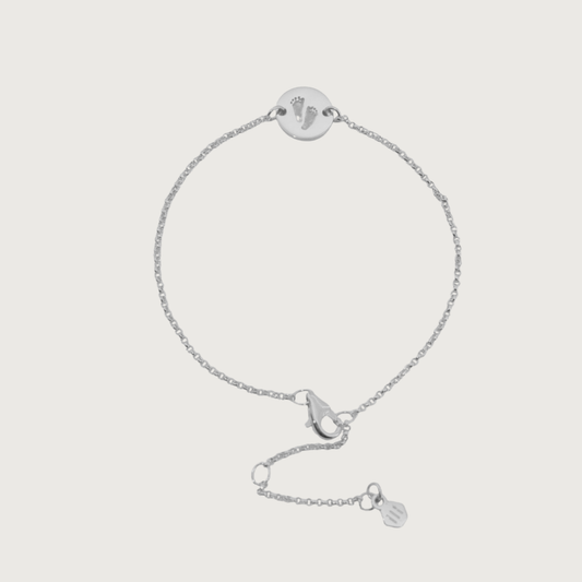 Custom bracelet engraved with footprints — sentimental sterling-silver keepsake.
