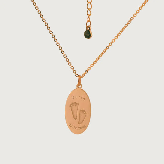 Oval Dario Necklace in rose gold plated with engraved baby footprints, name, and birthdate – custom keepsake jewelry by Chapters of Joy.