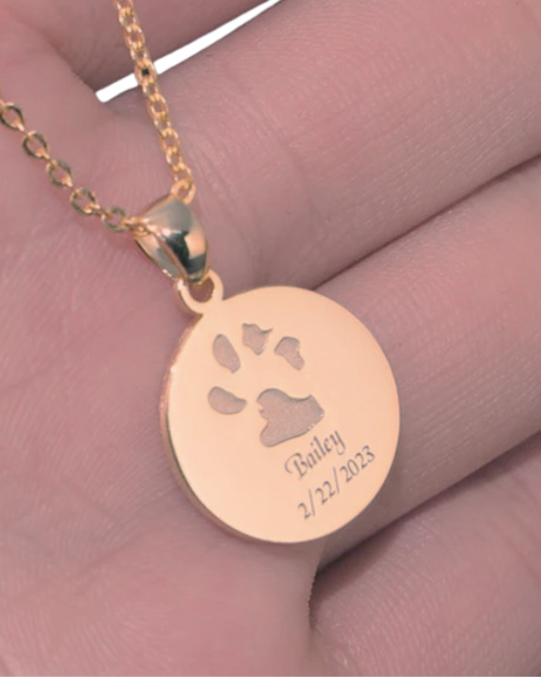 The Bailey Necklace engraved with custom dog paw print and name in rose gold plated necklace.