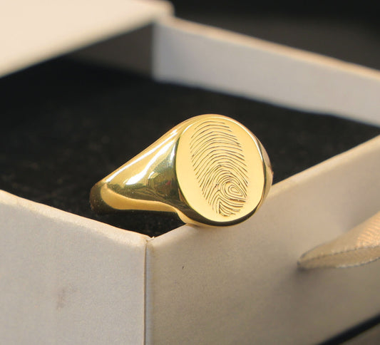 Custom gold signet ring with fingerprint engraving in keepsake box