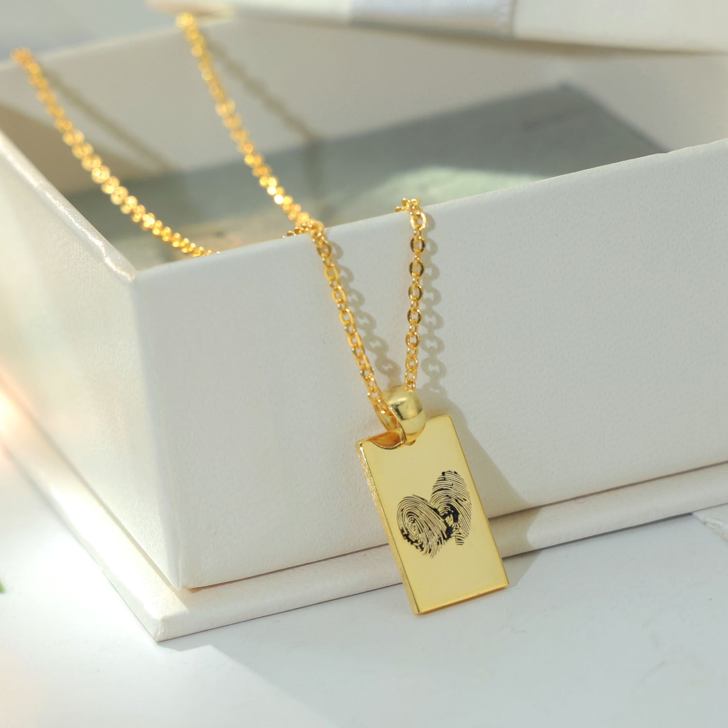 Gold heart pendant engraved with two fingerprints — personalized keepsake jewelry by Chapters of Joy