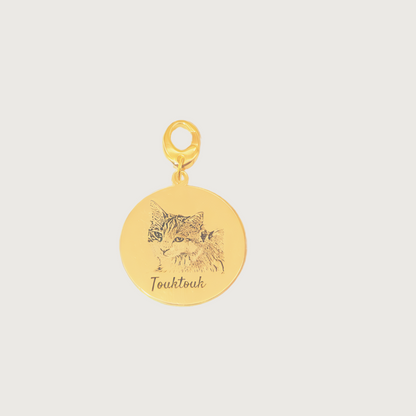 Gold plated Duo Tag engraved with two cat faces, symbolizing the bond between beloved companions.