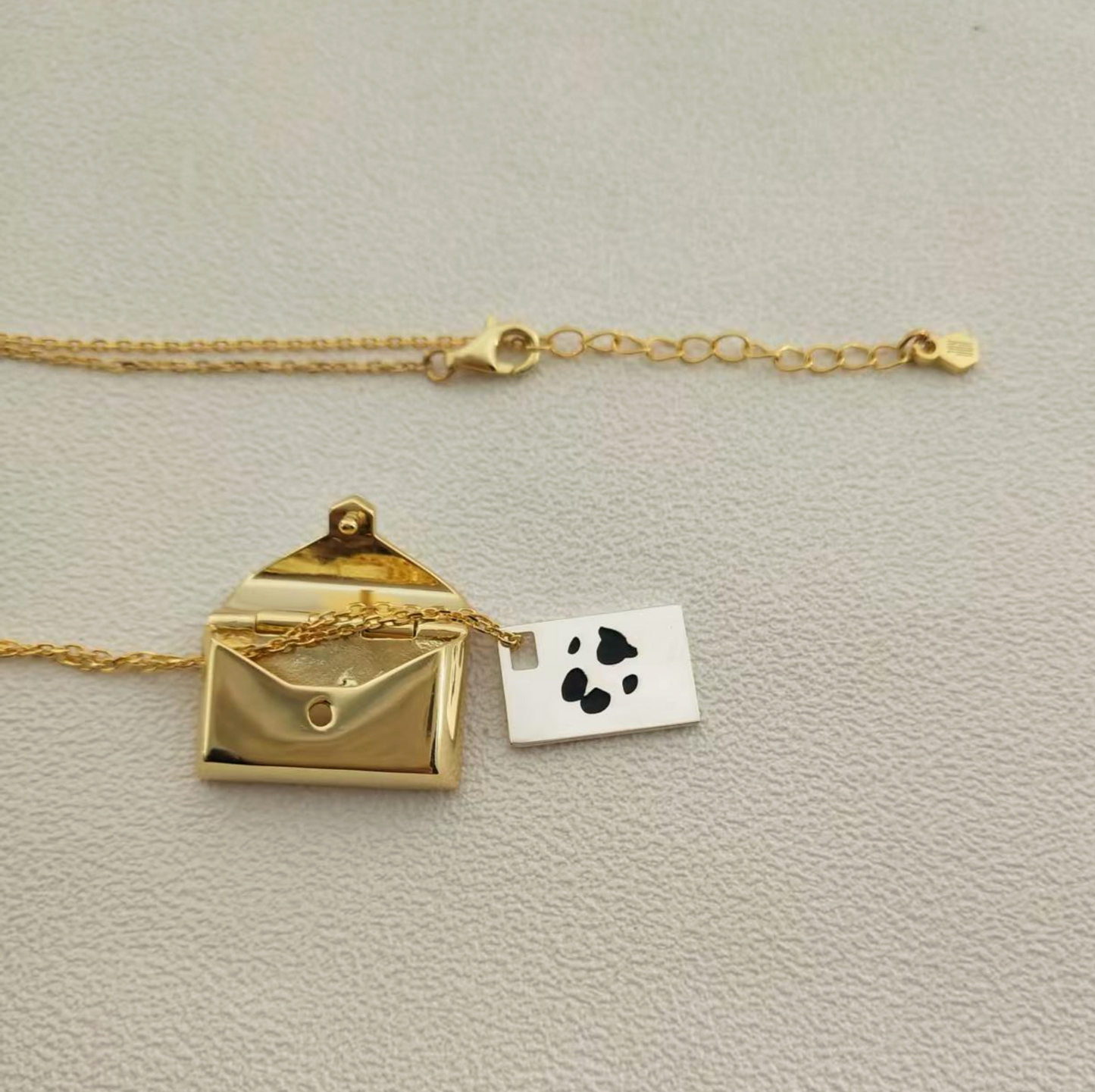 Lunelle envelope locket with paw print engraving inside