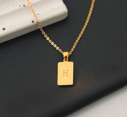 Sterling silver, gold plated rectangular pendant with engraving the letter 'H' on the front.