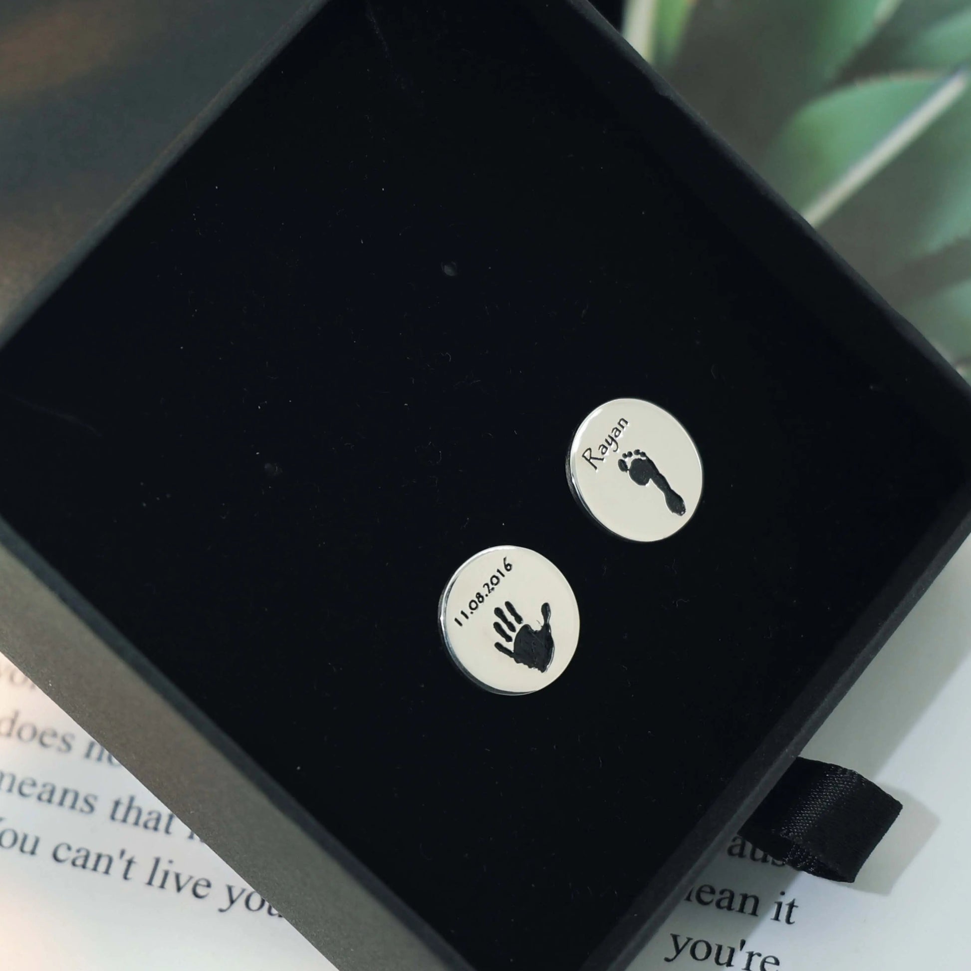 Round silver cufflinks engraved with a baby handprint and footprint — custom engraved cufflinks by Chapters of Joy.