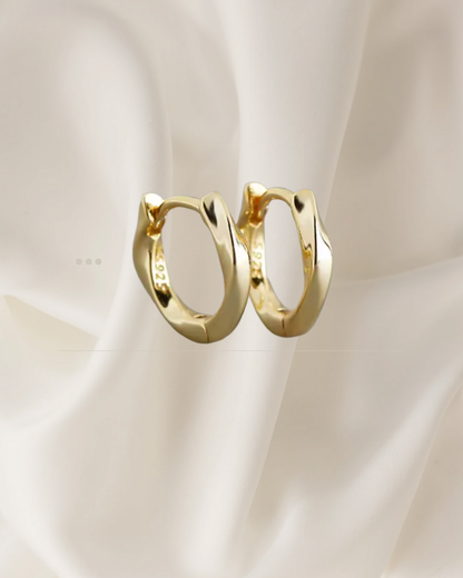 Sculpted gold hoop earrings with gentle flowing curves — Wavelet Hoops by Chapters of Joy.