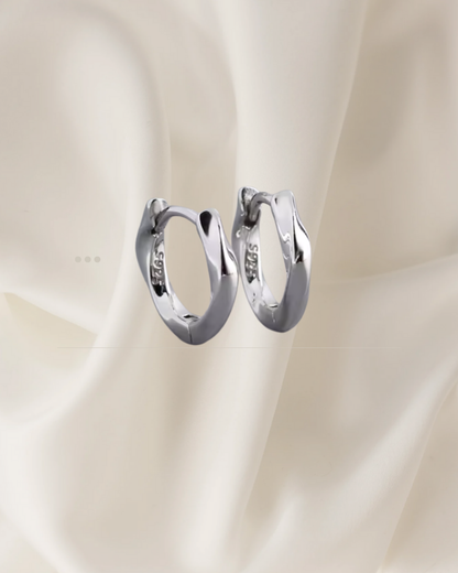 Sculpted silver hoop earrings with gentle flowing curves — Wavelet Hoops by Chapters of Joy.