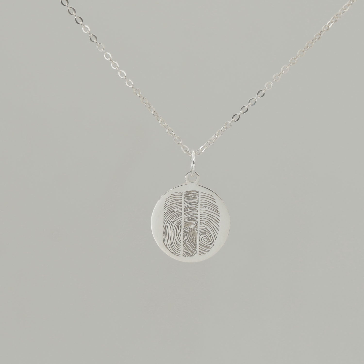 Custom engraved pendant with fingerprints and ‘Together as one’ inscription