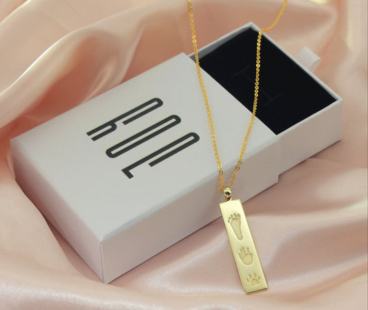 Close-up of The Dila Pendant with engraved handprint on gold-plated sterling silver
