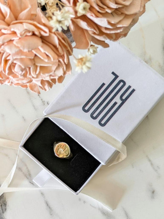 Jac Signet Ring in gold-plated sterling silver with engraved baby’s handprint on the front and optional inner band personalization.

