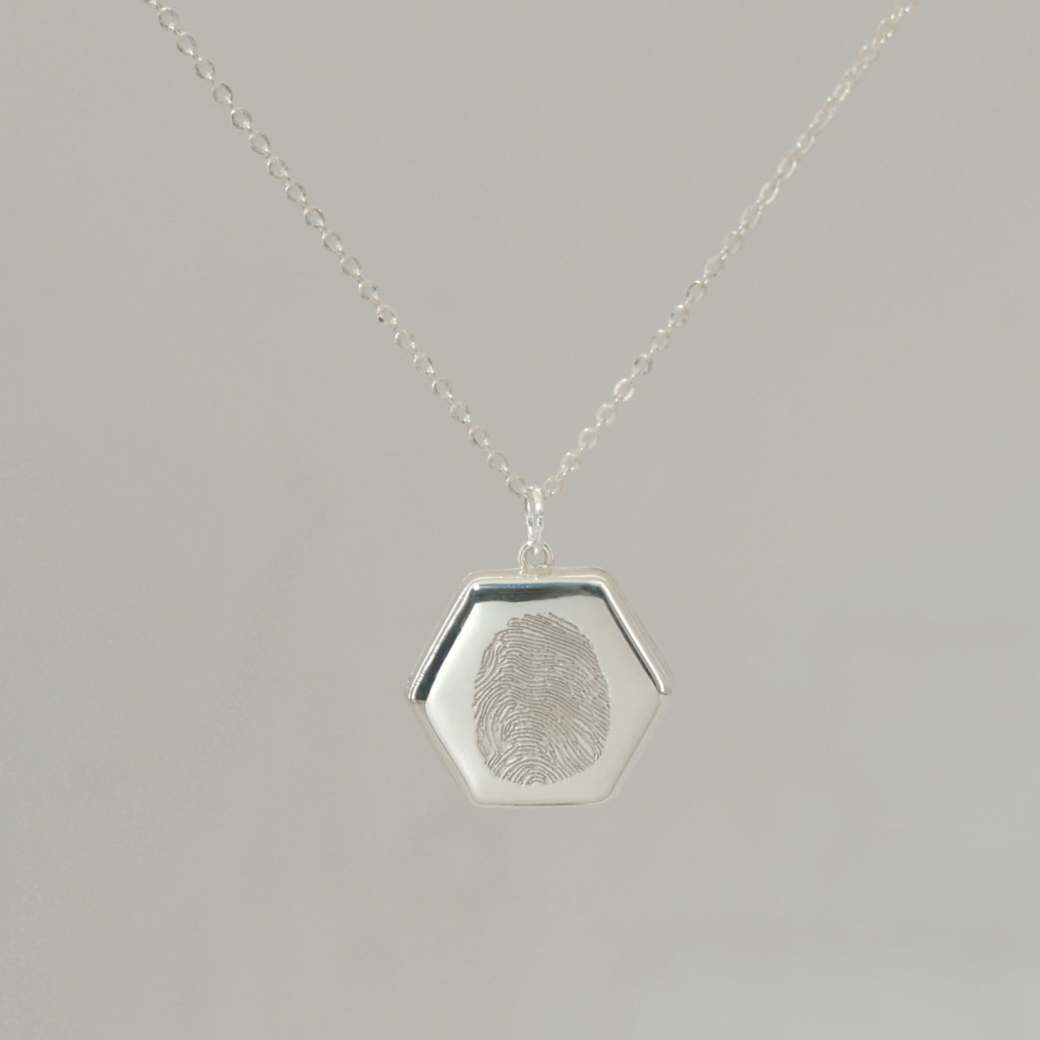Sterling silver Lina Locket with fingerprint engraving, handwritten message, and UV-lasered photograph inside.